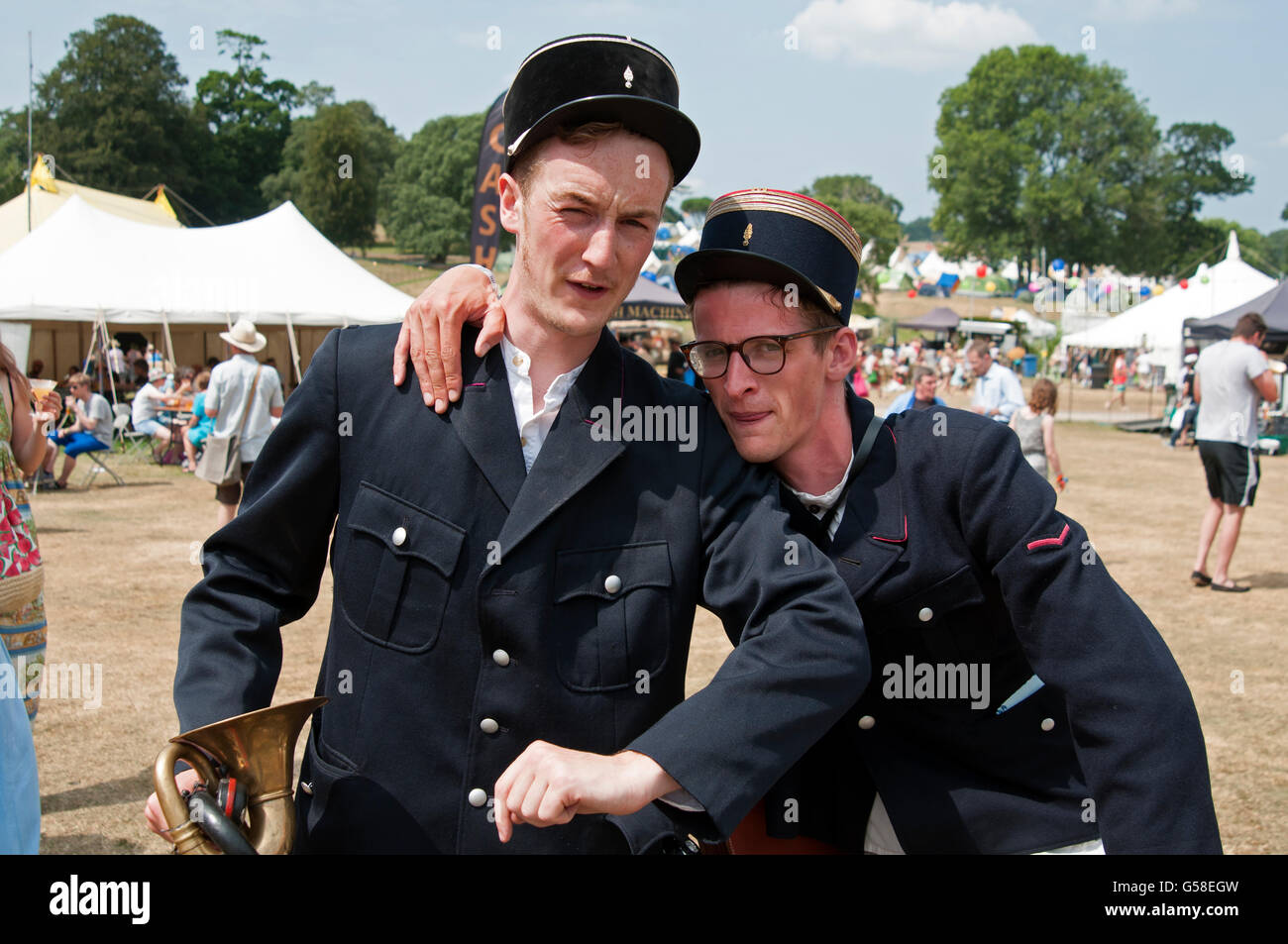 Two entertainers dressed as French policemen on bicycles at the Port Eliot Festival Cornwall UK Stock Photo