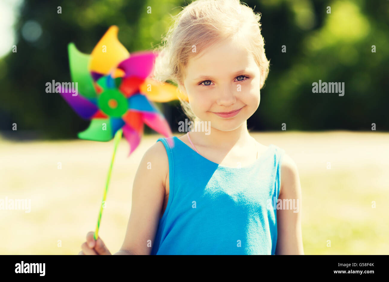 happy little girl with colorful pinwheel at summer Stock Photo - Alamy