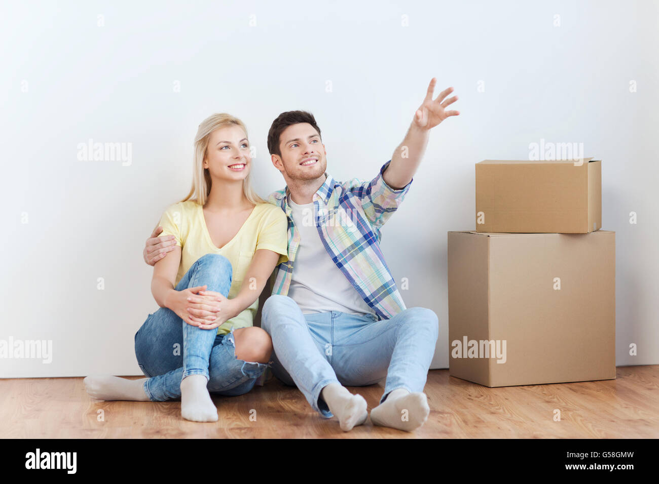 couple with boxes moving to new home and dreaming Stock Photo - Alamy