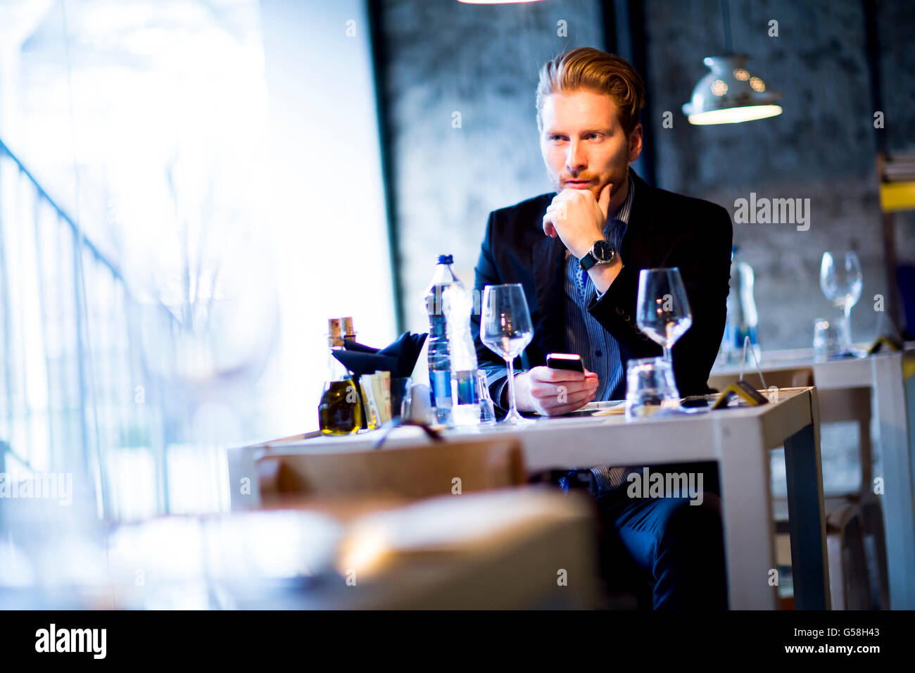 Man sitting alone at the table in the restaurant Stock Photo