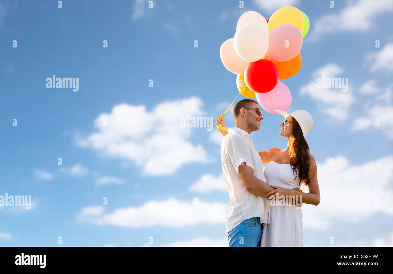 smiling couple with air balloons outdoors Stock Photo - Alamy