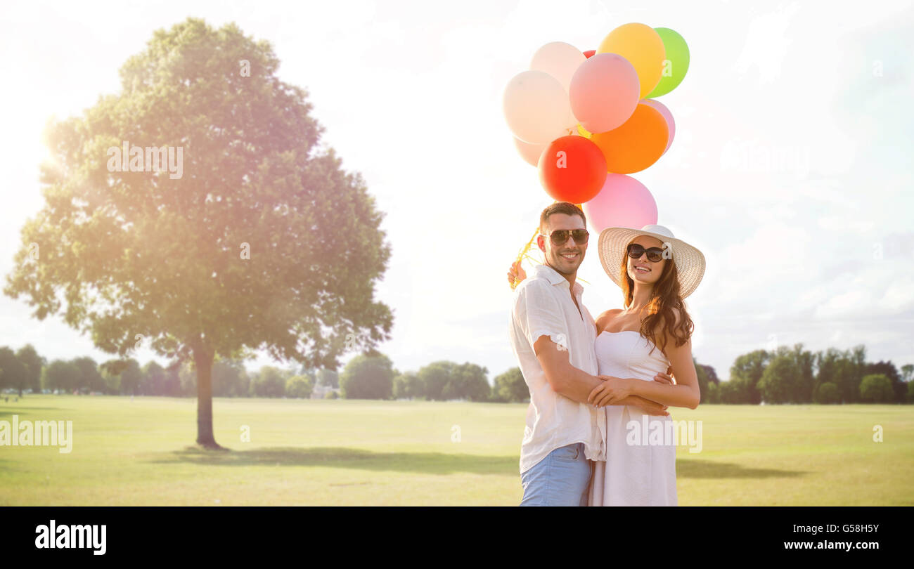 smiling couple with air balloons outdoors Stock Photo - Alamy