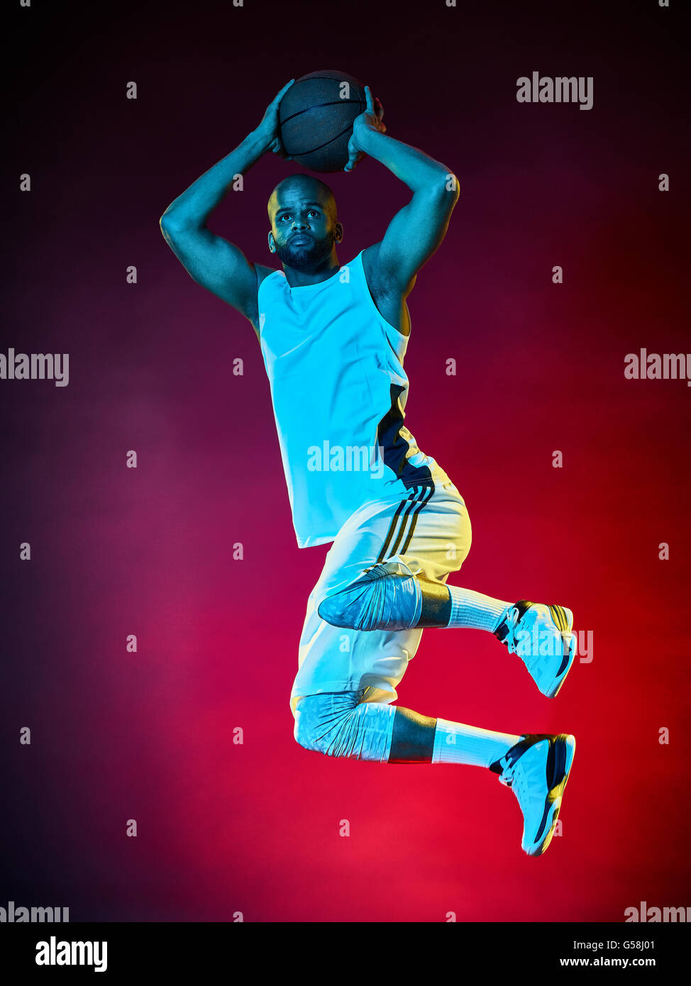 one basketball player man Isolated on black background Stock Photo - Alamy