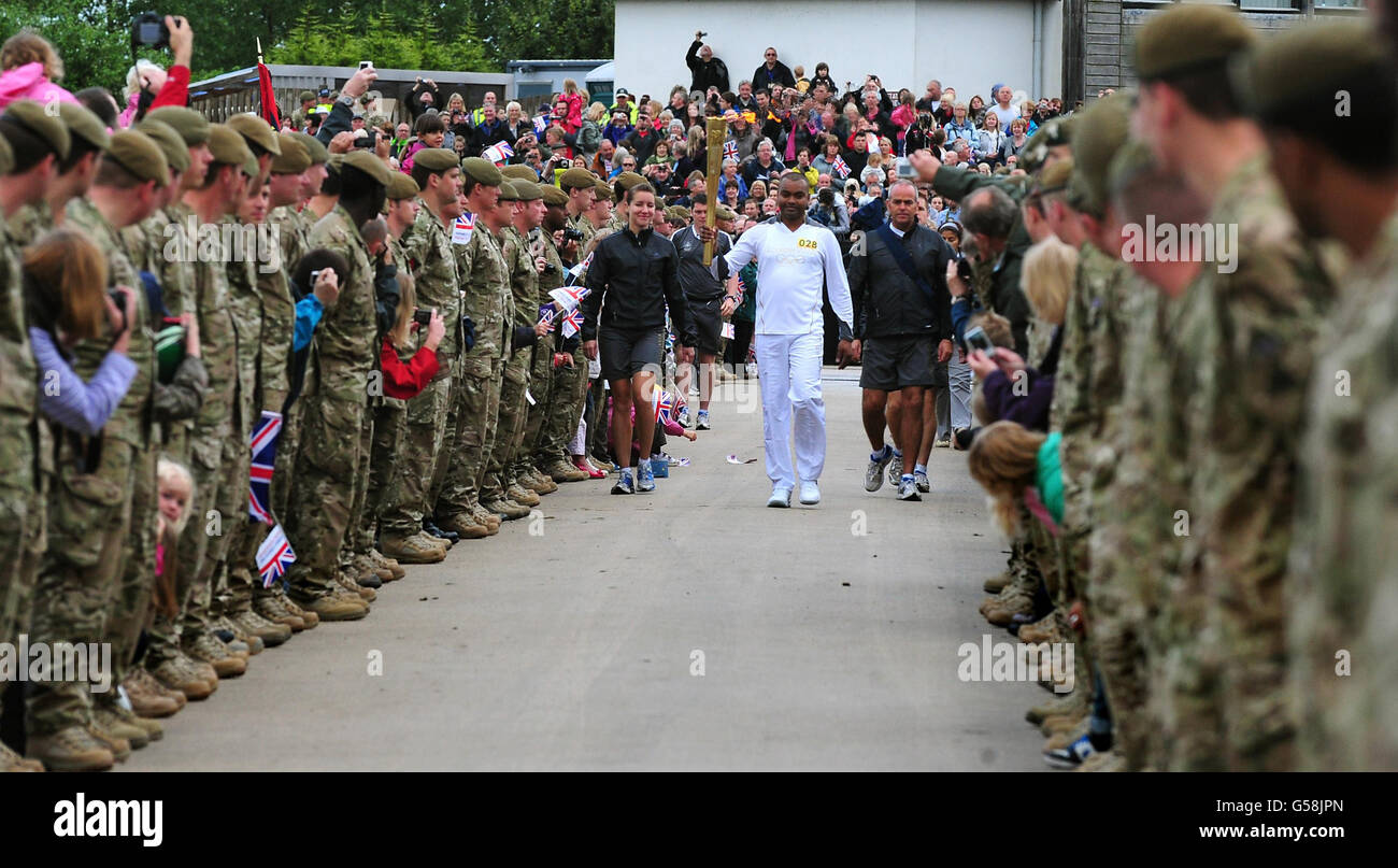 Corporal Johnson Beharry VC carries the torch at the National Memorial Arboretum on Armed Forces Day. Stock Photo