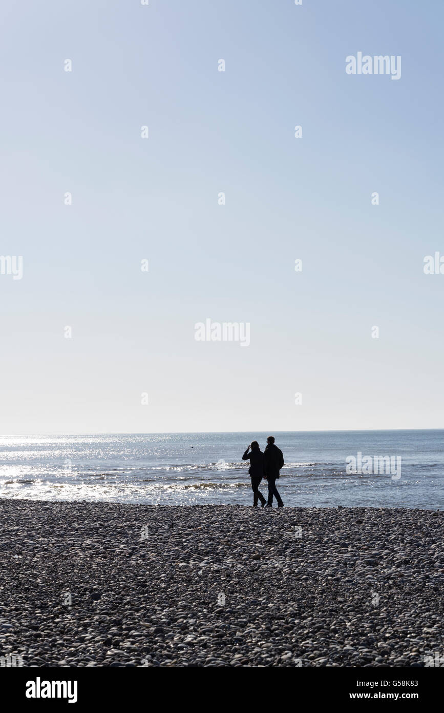 Couple walking on beach, Budleigh Salterton, Devon, England Stock Photo
