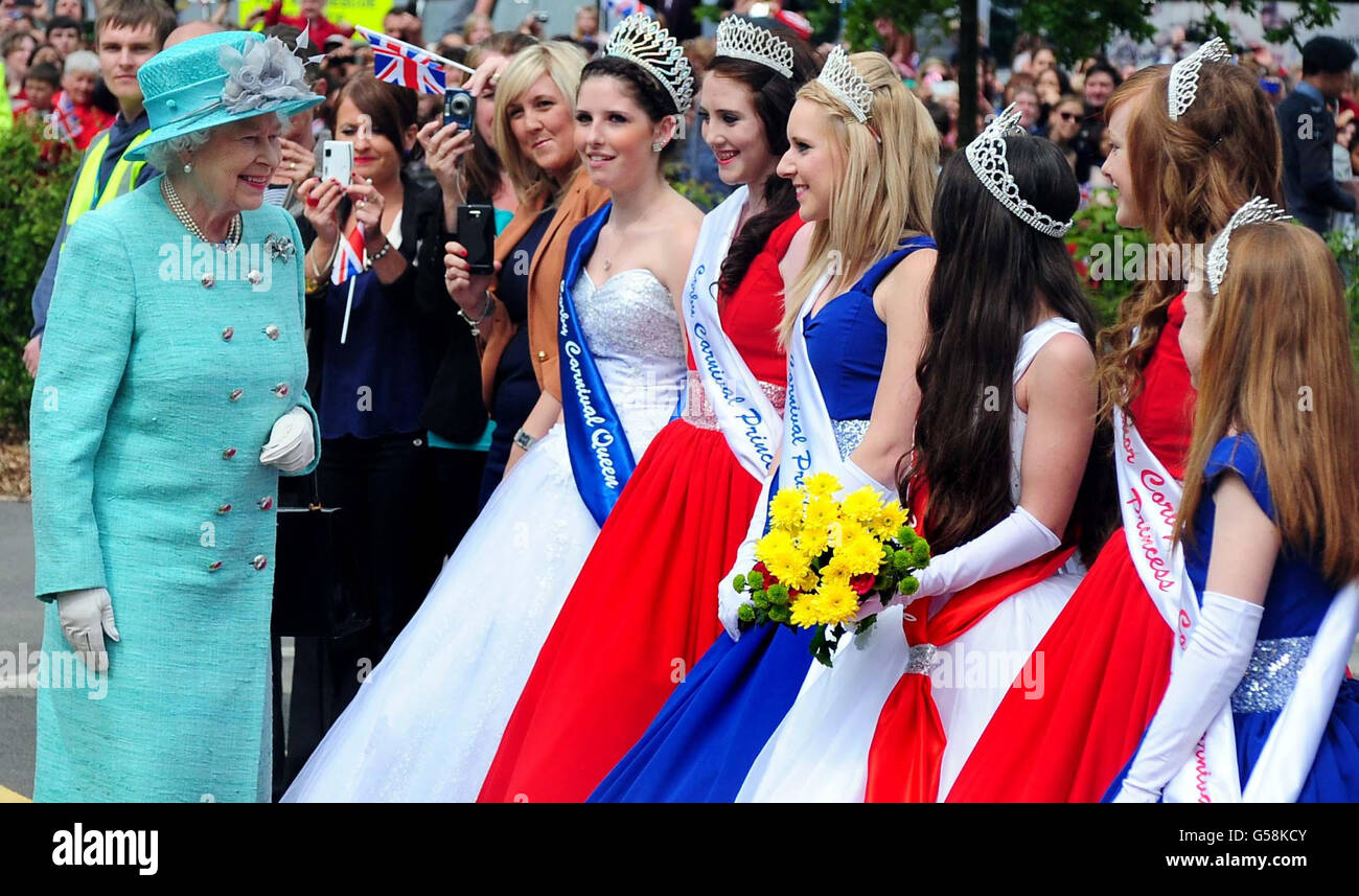 Queen Elizabeth II meets Beauty Queens (names not given) during a visit to the Olympic Swimming Pool and The Cube at Corby on the latest leg of the Diamond Jubilee tour. Stock Photo