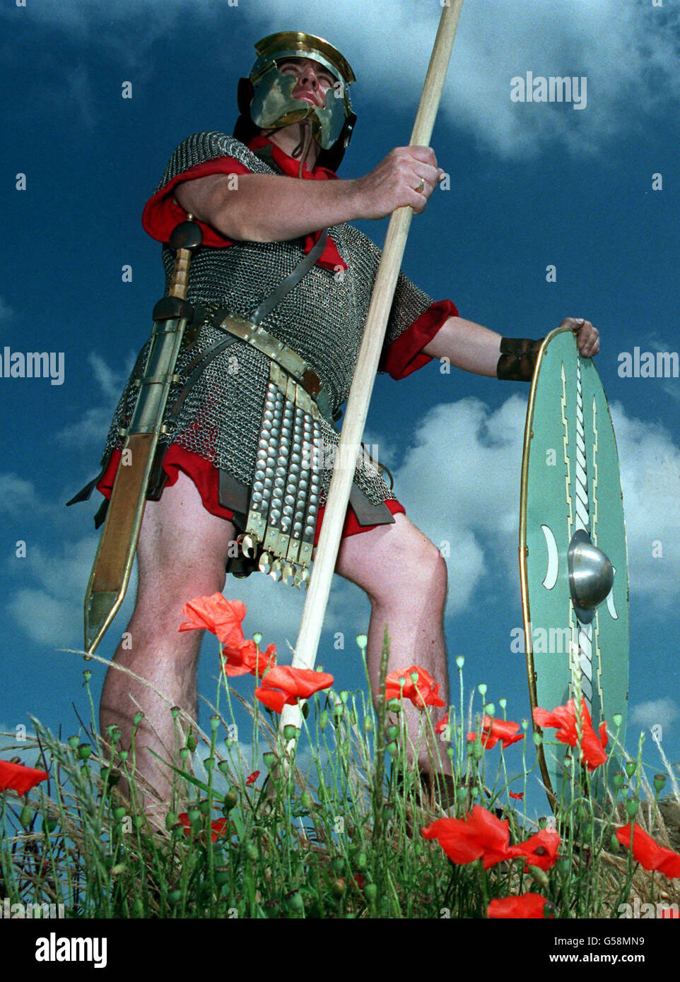 ROMAN BRITAIN: A man dressed in the equipment of a Roman army Auxiliary, circa late 1st century AD, stands near the site of the dig at Stanway, nr Colchester, where medical instruments have been unearthed. Colchester was an important Roman city, then known as Camulodunum. Stock Photo
