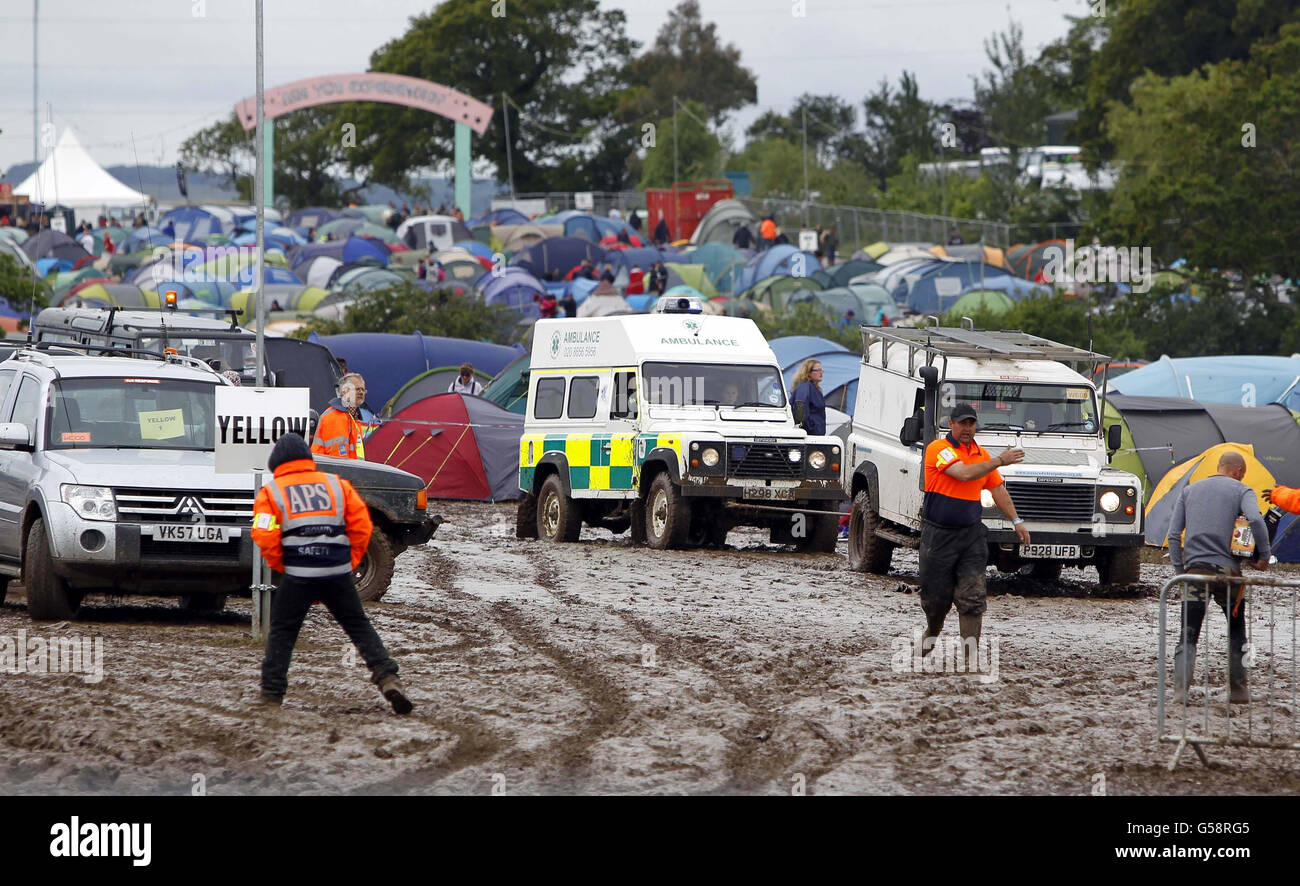 An ambulance is towed off the site at the Isle of Wight festival, after heavy rains turned the site into a mudbath causing traffic chaos. Stock Photo
