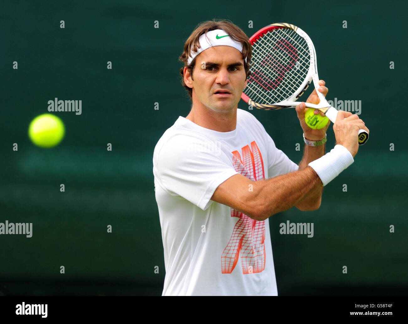 Switzerland's Roger Federer on the practice courts during a practice day of the 2012 Wimbledon Championships at the All England Lawn Tennis Club, Wimbledon. Stock Photo