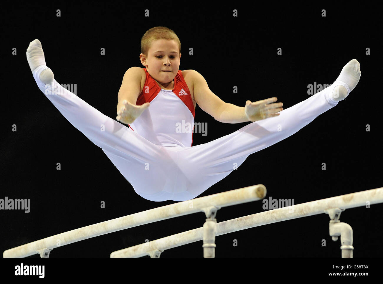 South Essex Gymnastics club's Brinn Bevan performing on parallel bars during the individual apparatus finals during day five of the British Jumping Derby Meeting at the All England Jumping Course, Hickstead. Stock Photo