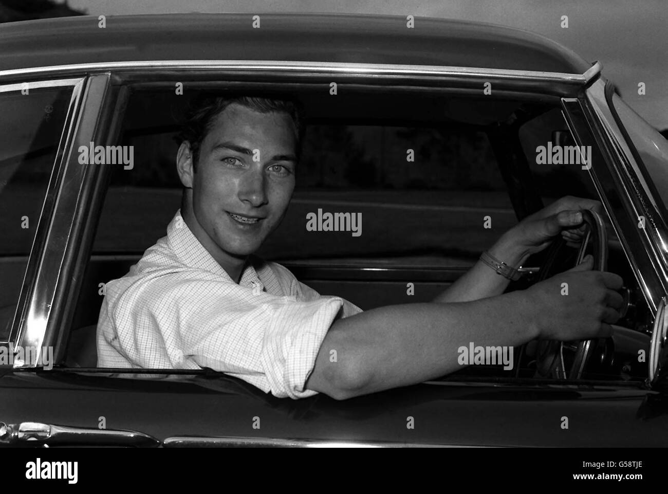 1962: Prince William of Gloucester, who loves driving, pictured at the wheel of his car at his home, Barnwell Manor, near Peterborough. The Prince, elder son of the Duke and Duchess of Gloucester, celebrates his 21st birthday on December 18th. He is 7th in line of succession to the throne. (Killed in air accident 28/8/72). Stock Photo