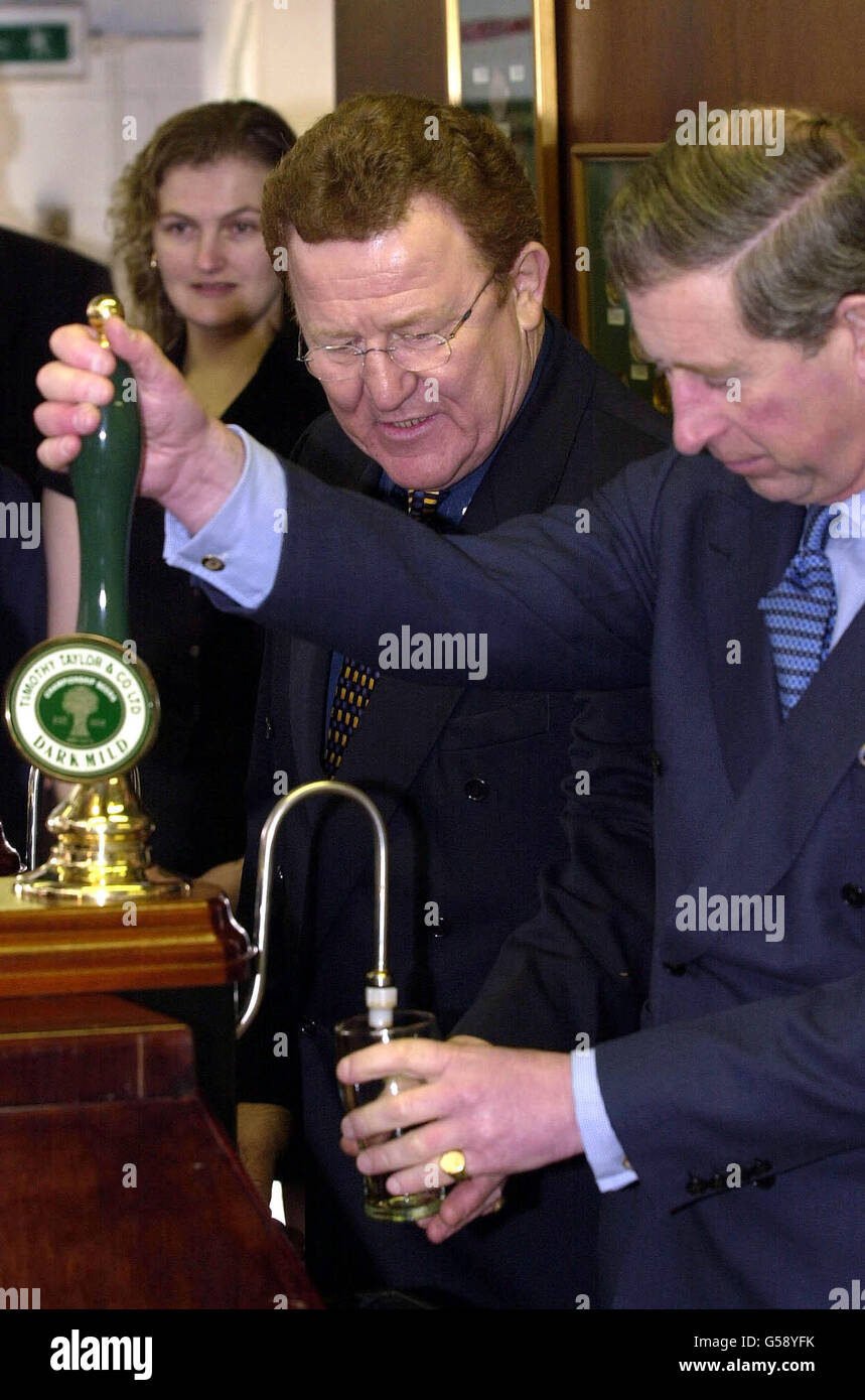 The Prince of Wales pulls a half pint of beer during his visit to Timothy Taylors brewery in Keighley, West Yorkshire. Stock Photo