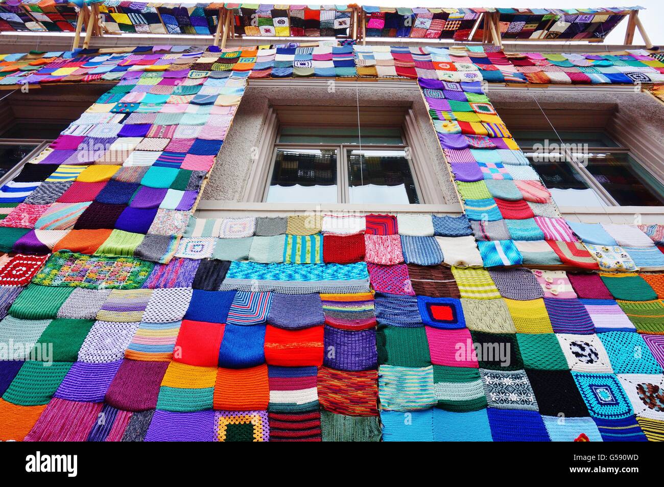 A building covered with a colorful knitted quilt on Main Street in the historic downtown of Ames, Iowa Stock Photo