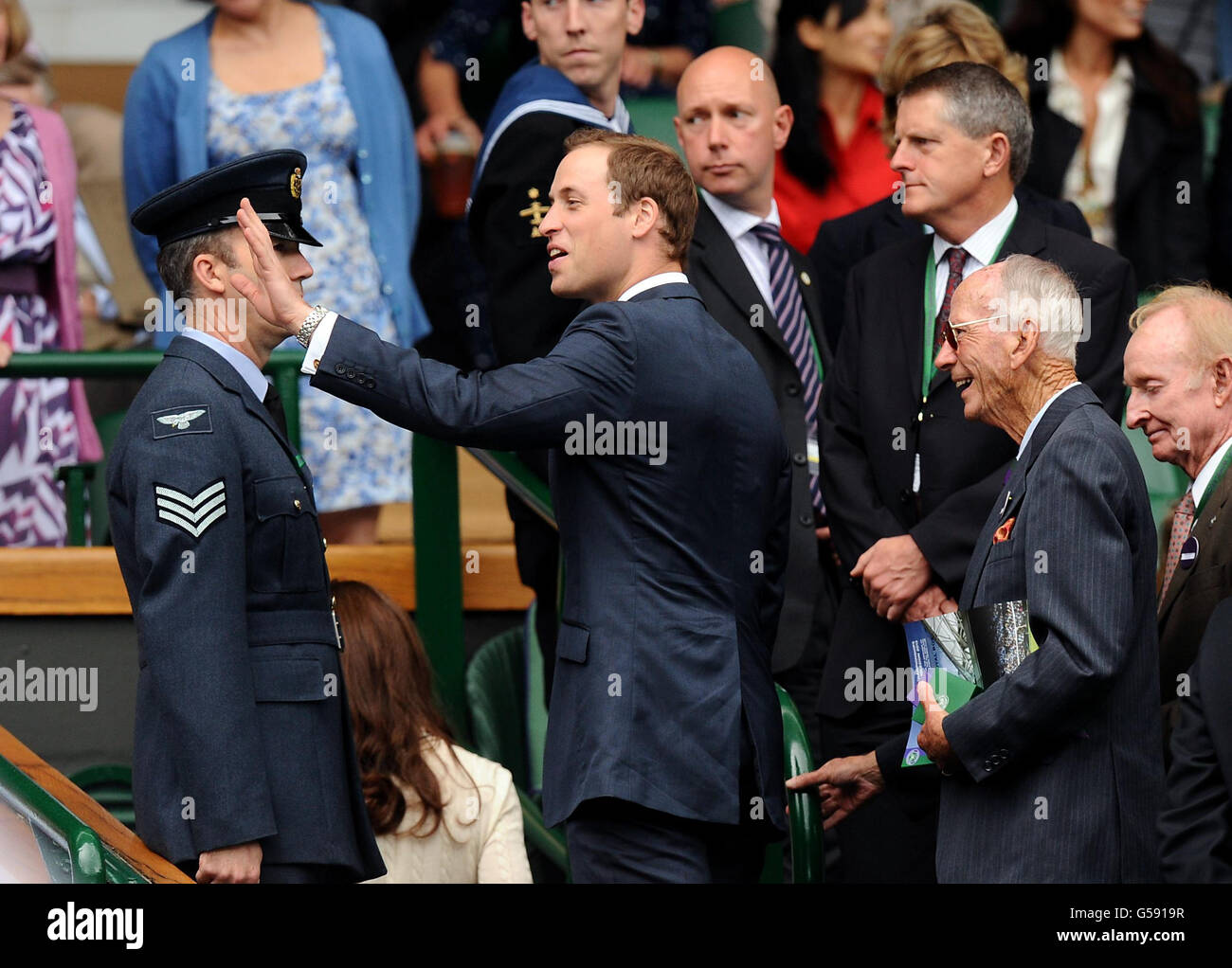 The Duke of Cambridge waves to the crowd during a break for rain on day nine of the 2012 Wimbledon Championships at the All England Lawn Tennis Club, Wimbledon. Stock Photo