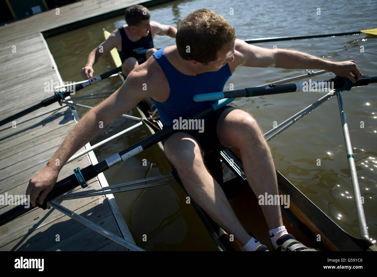 Two rowers adjust their oars before going out on a morning session on