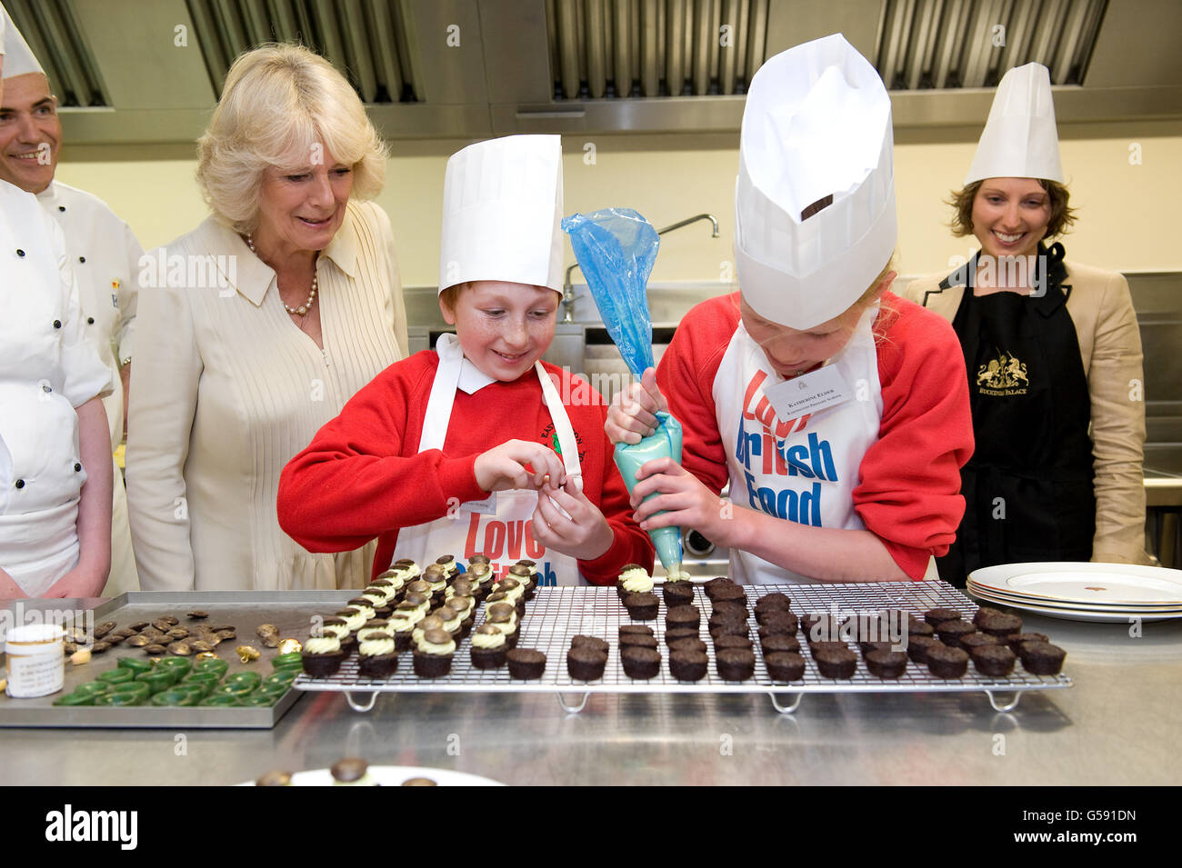 The Duchess of Cornwall meets Cory Hogg, a pupil at Eastington Primary School, Gloucestershire, in the kitchens at Buckingham Palace, in central London. Stock Photo