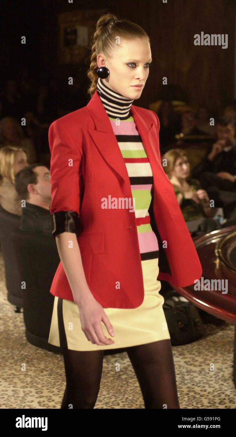 A multi-striped woollen polo neck sweater worn with wool mini skirt with side stripe detail and poster-paint red tailored jacket from the Martin Kidman show in central London during the first day of London Fashion Week Autumn/Winter 2001. Stock Photo