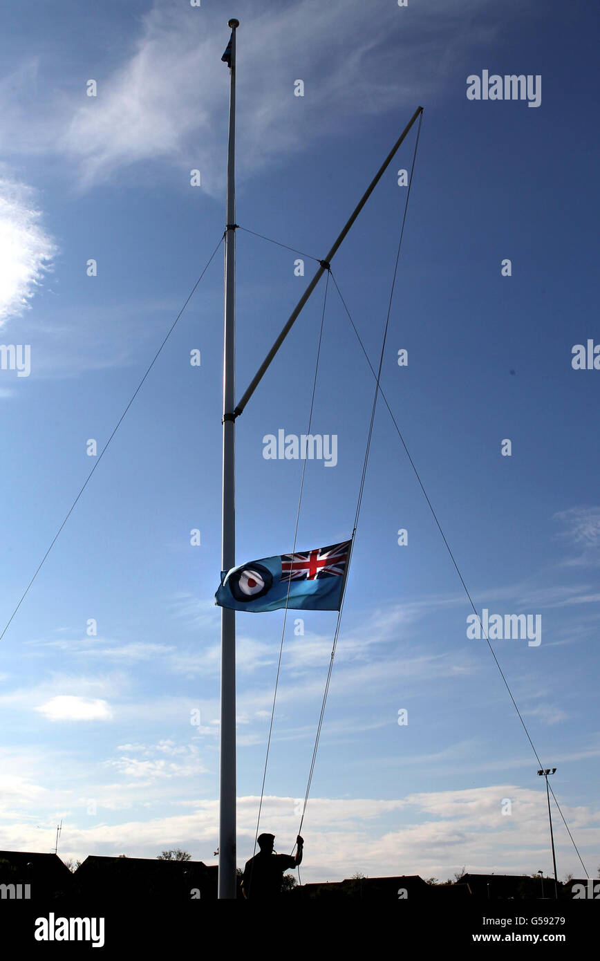 A flag is lowered at RAF Lossiemouth after flying at half mast following an incident in which two RAF Tornados crashed off the coast of Scotland. Stock Photo