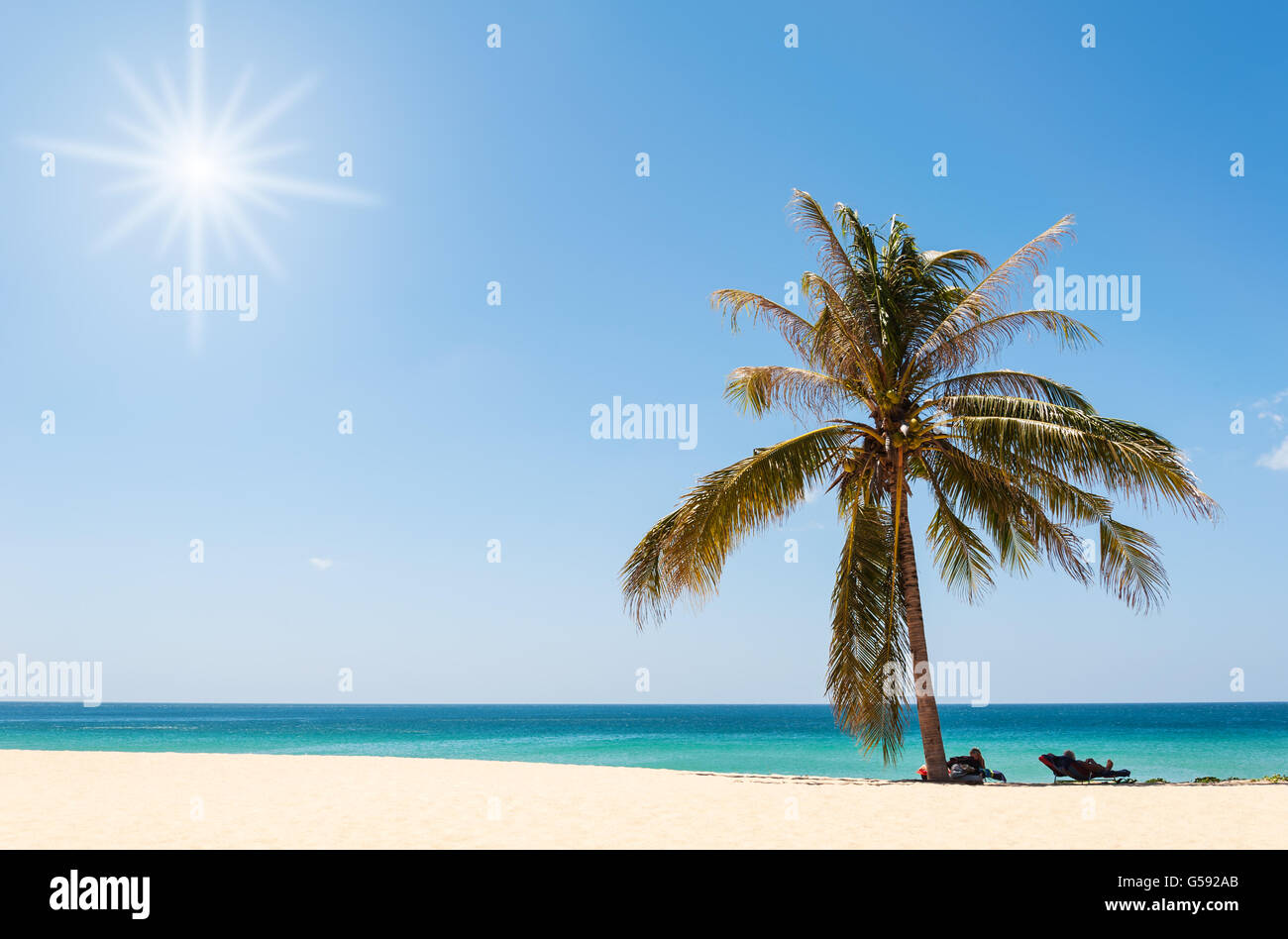 Beautiful beach with blue sea and blue sky and over light the sun Stock Photo