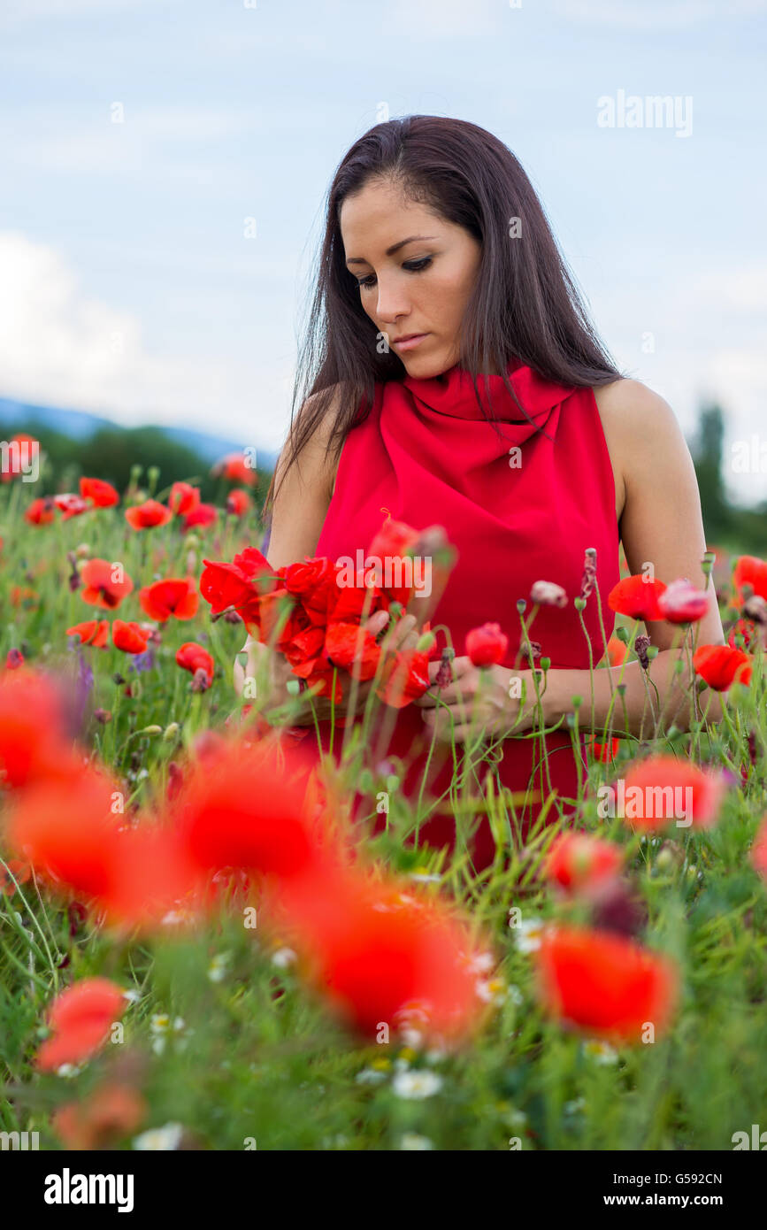 young girl with a beautiful dress in a field of poppies Stock Photo - Alamy