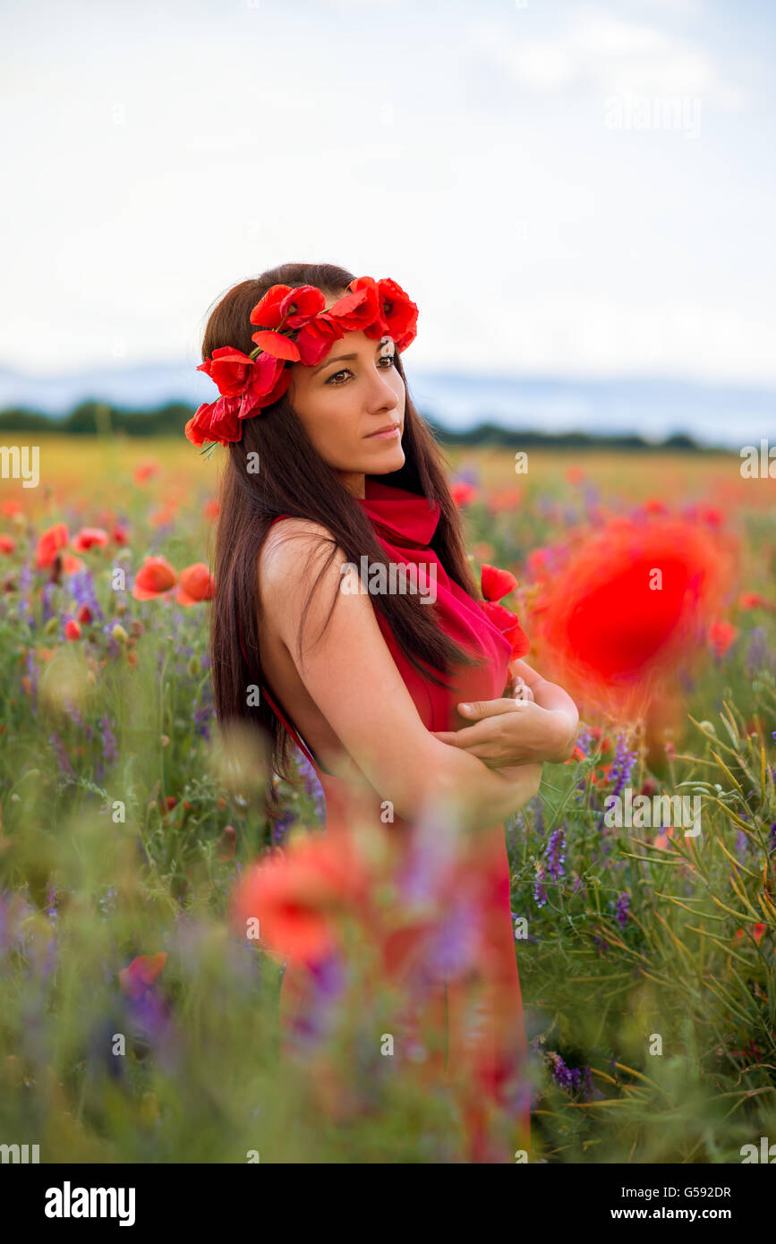 young girl with a beautiful dress in a field of poppies Stock Photo - Alamy