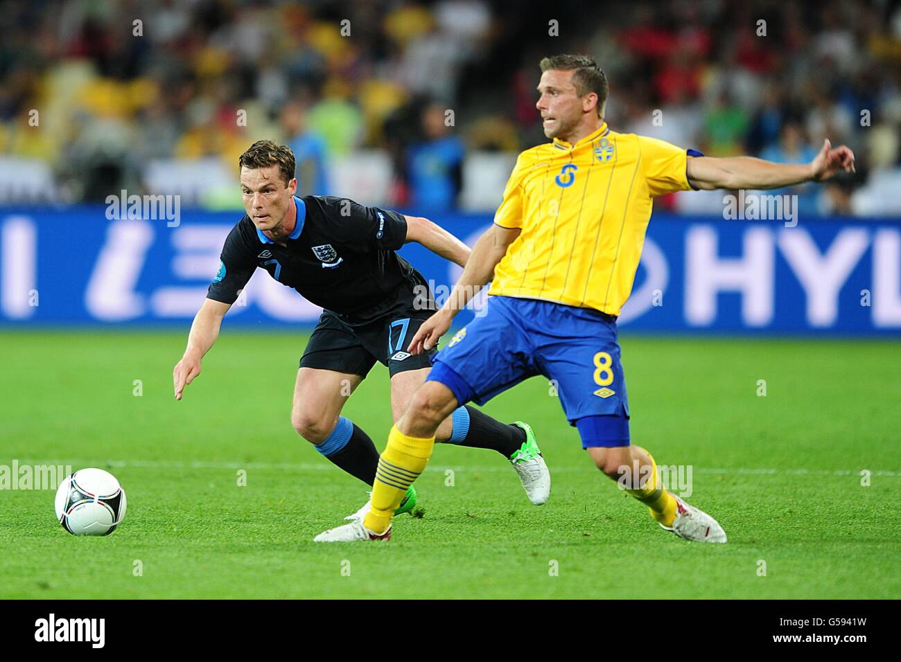 Soccer - UEFA Euro 2012 - Group D - Sweden v England - NSC Olimpiyskiy. Sweden's Anders Svensson and England's Scott Parker (left) battle for the ball Stock Photo