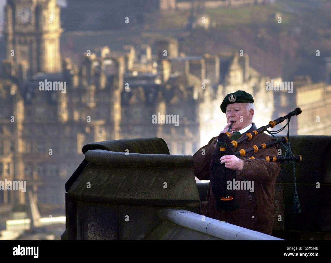 Bill Millin plays his bagpipes at Edinburgh Castle in Scotland. The lone piper who gained world-wide fame when he helped lead British Commandos during the D-Day landings ensured his possessions used at the historic event would be protected for all time. * The skirl of Bill Millin's pipes led the first Commando Brigade as it stormed Sword Beach on the first day of the Normandy landings on June 6, 1944. The 21-year-old, who had left Sandyhills near Glasgow to join the commandos, had been ordered to play - against the wishes of the top brass - by the brigade commander Lord Lovat, and became one Stock Photo