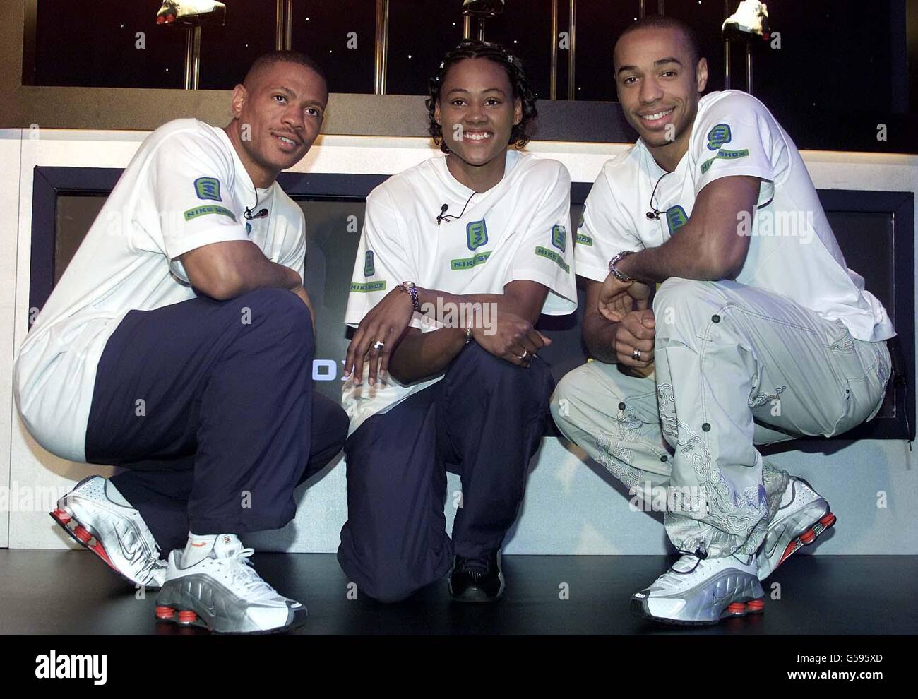 The world's fastest man and woman, US sprinters Maurice Greene (L) and  Marion Jones with Arsenal's Thierry Henry pose in front of the new Nike  Shox running shoes at the product's launch