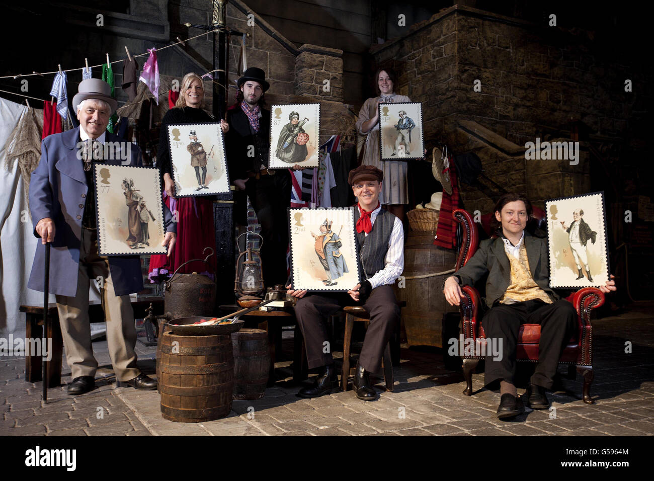 (Left to right) Actors Colin Mepstead, Jen Lane, Ash Tucker, Sean Charles Rogers, Cathryn Shine and Dave Washbrook portray Dickensian characters at Charles Dickens World in Chatham, Kent to help launch Royal Mail's latest stamp issue celebrating the 200th anniversary of Charles Dickens' birth. Stock Photo