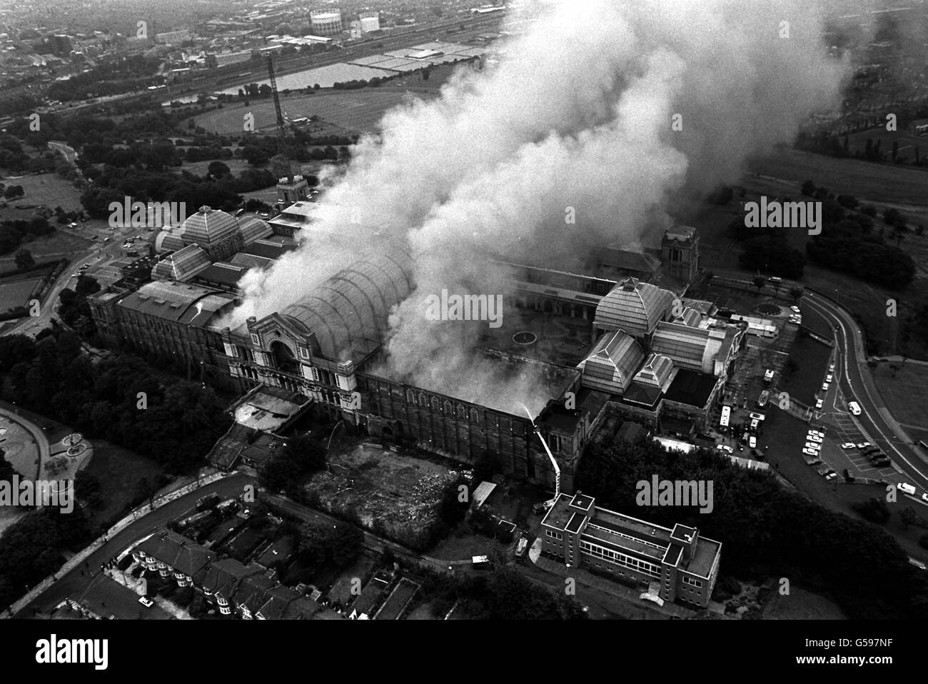 An aerial view of London's historic Alexandra Palace where more than 200 firemen were fighting a major blaze at the Victorian complex. The Great Hall (the barrel-shaped structure shrouded in smoke) of the Palace, built in 1875, was severely damaged. No one is thought to have been hurt. Stock Photo