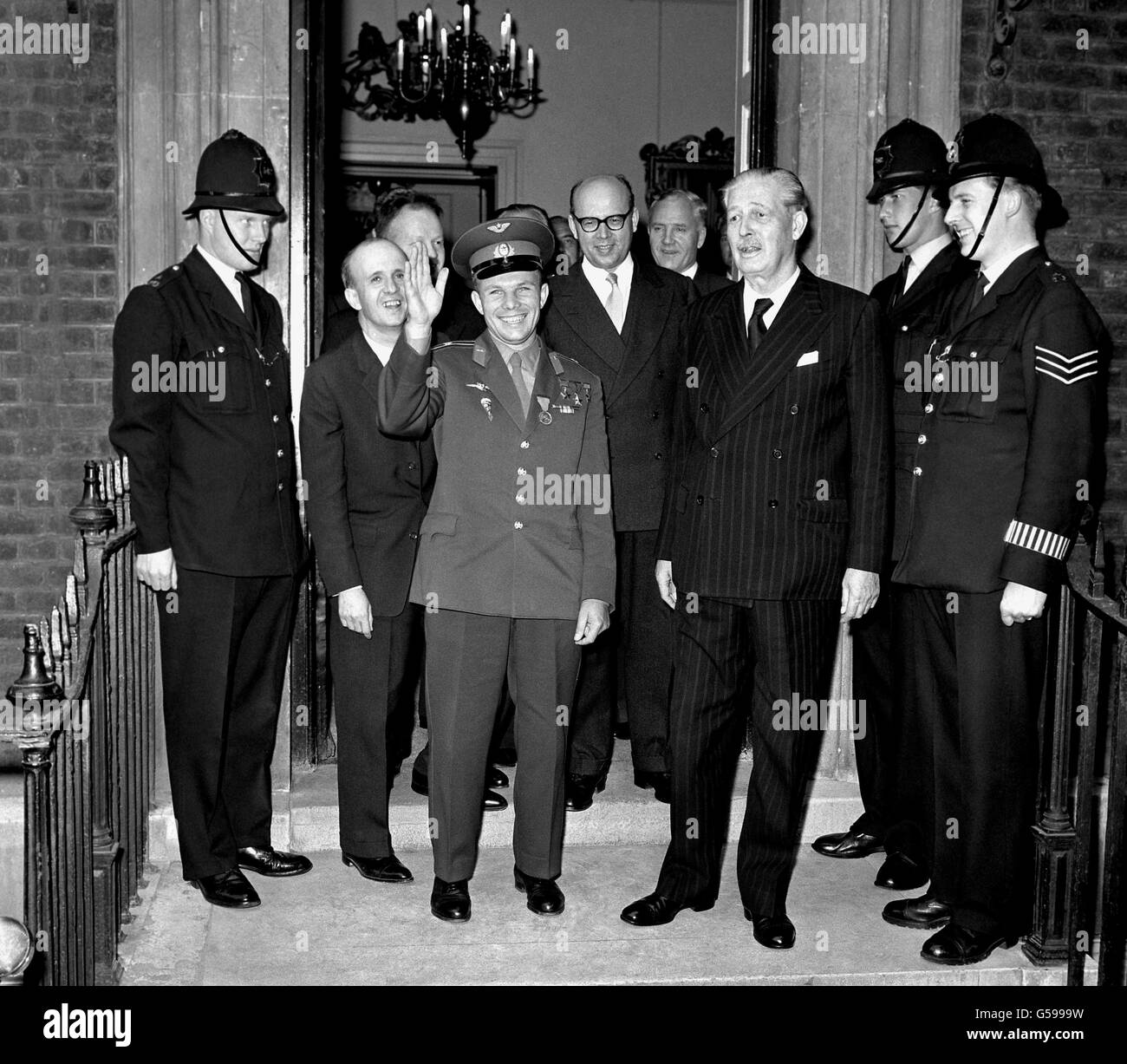 12TH APRIL: On this day in 1961 27 year old Major Yuri Gagarin became the first man in space. 1961: There are smiles even from the police as cheery Major Yuri Gagarin waves to bystanders on his departure from Admiralty House, London. With the Soviet Cosmonaut are seen Mr Harold Macmillan (r) and Mr Aleksander Soldatov (glasses), the Soviet Ambassdor in London. Stock Photo