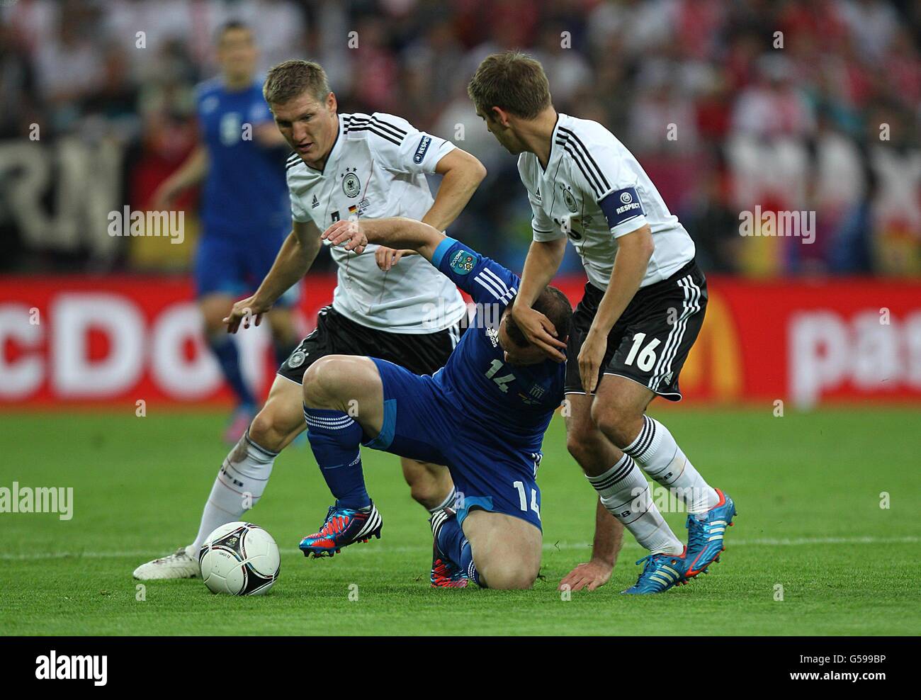 Greece's Dimitris Salpingidis battles for the ball with Germany's Philip Lahm (right) and Bastian Schweinsteiger (left) Stock Photo