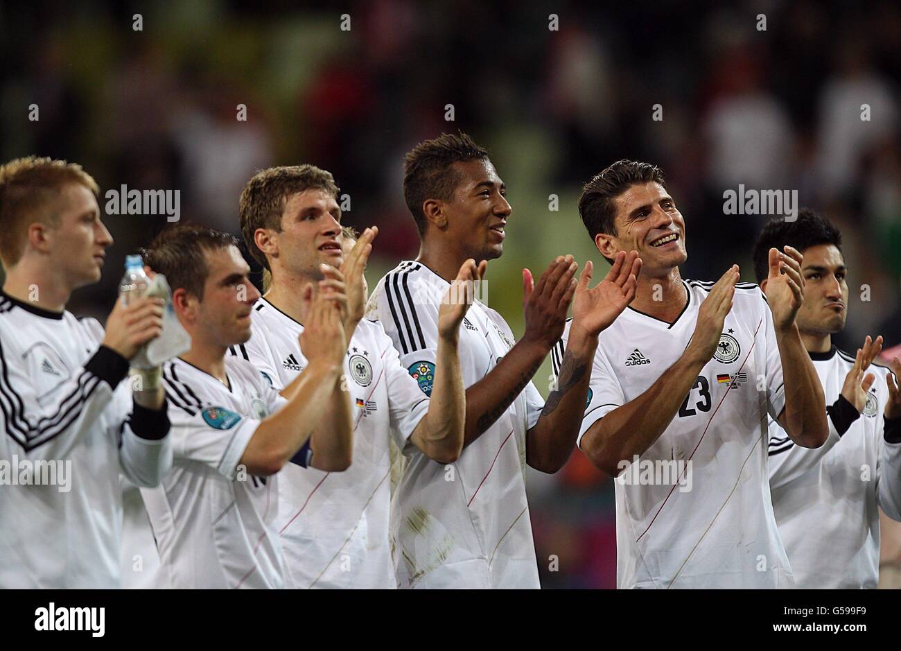 Soccer - UEFA Euro 2012 - Quarter Final - Germany v Greece - Arena Gdansk. Germany's Mario Gomez (right), Jerome Boateng (centre) and Thomas Muller (third from left) celebrate with his team-mates after the game Stock Photo