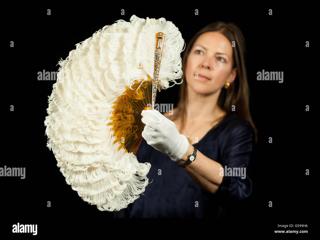 Exhibition Curator Caroline de Guitaut holds a diamond-set Coronation Fan, made for Queen Alexandra at the time of the coronation in 1902, part of the 'Diamonds: A Jubilee Celebration' exhibition, at Buckingham Palace, in central London, from 30 June to 8 July 2012, and 31 July to 7 October 2012. Stock Photo
