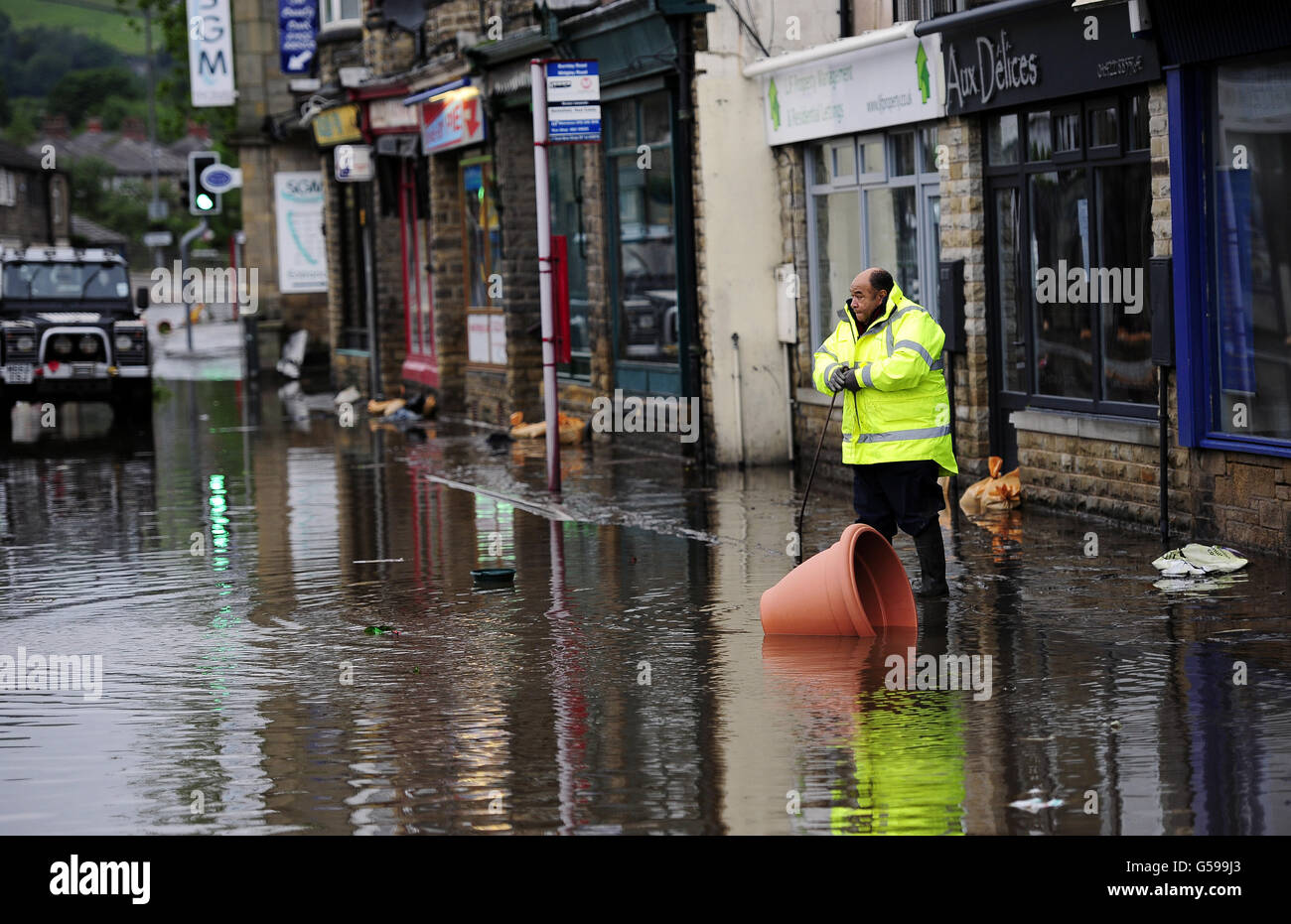 Floodwaters surrounds local shops in the centre of Mytholmroyd near Huddersfield, West Yorkshire, after torrential downpours brought flooding to swathes of northern England, forcing people to leave their homes as more than a month's worth of rain fell in 24 hours. Stock Photo