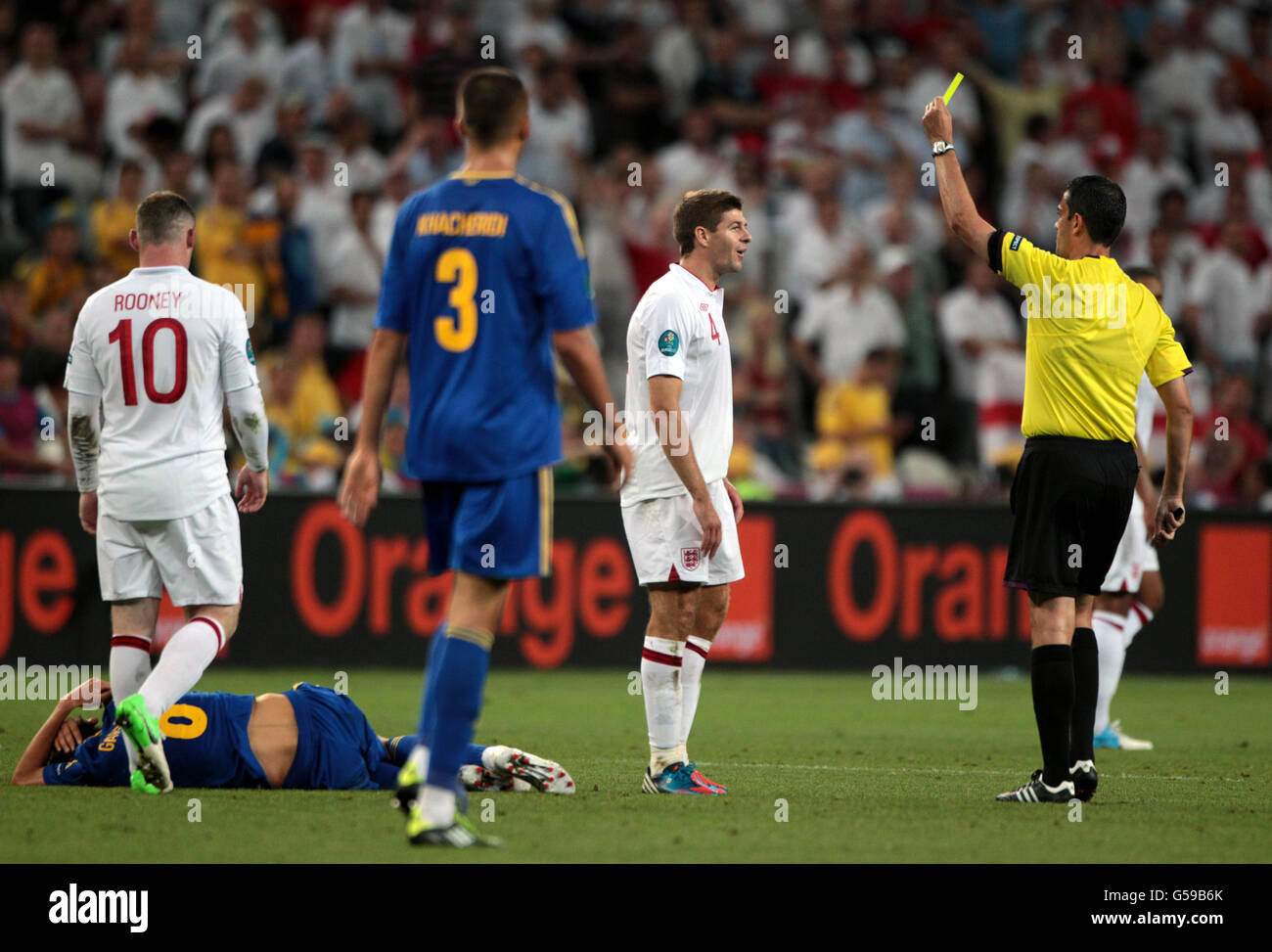 Soccer - UEFA Euro 2012 - Group D - England v Ukraine - Donbass Arena. England's Steven Gerrard is shown a yellow card by referee Viktor Kassai Stock Photo
