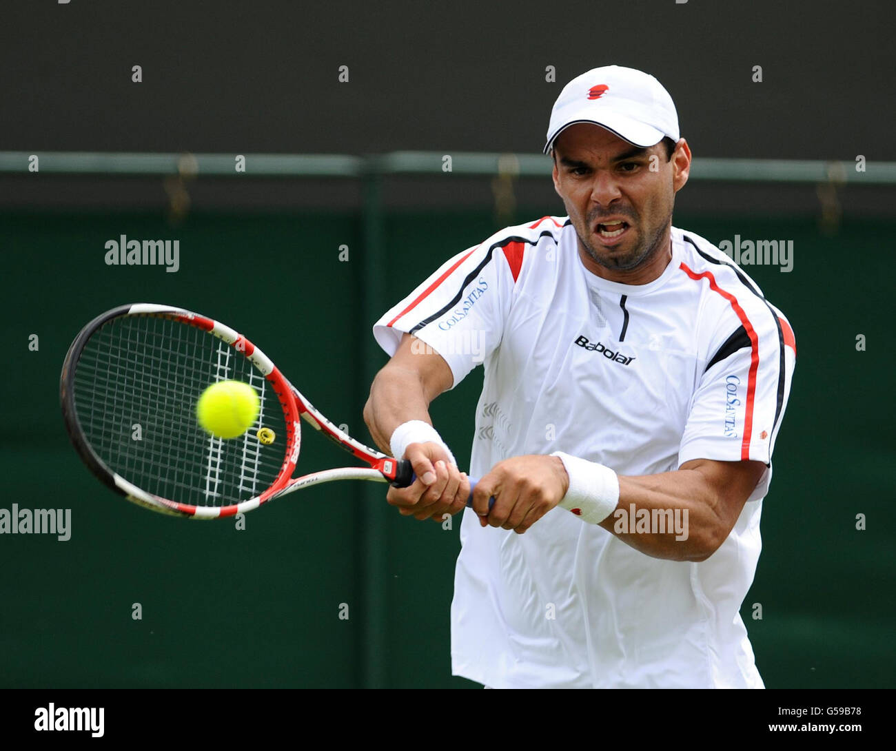 Colombia's Alejandro Falla in action against USA's John Isner during day one of the 2012 Wimbledon Championships at the All England Lawn Tennis Club, Wimbledon. Stock Photo