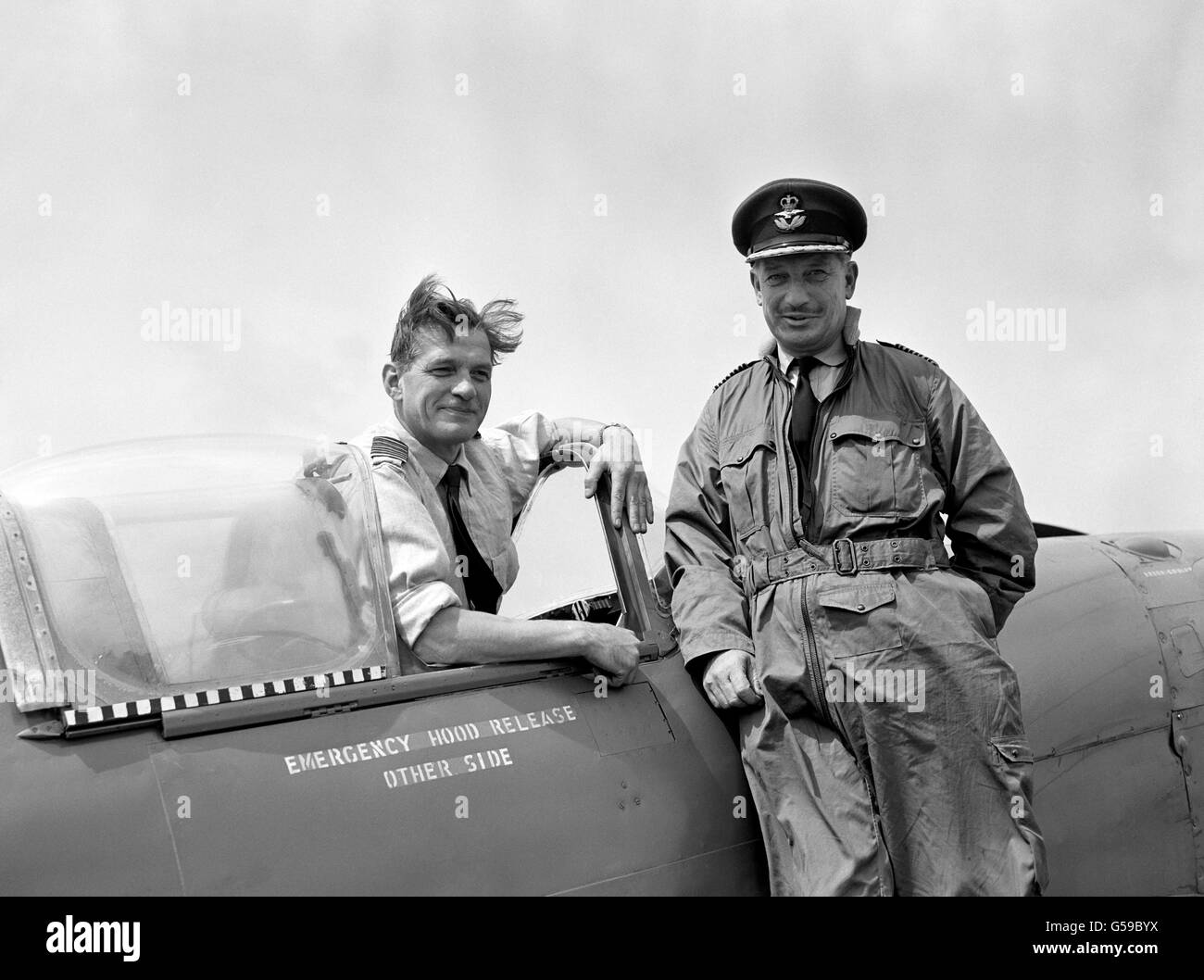 The end of a chapter in British history for RAF fighter pilots Group Captain James Edgar ('Johnnie') Johnson (in cockpit) and Group Captain James Rankin, seen at Biggin Hill, Kent, as they brought in two of the last three Spitfires for their 'retirement'. Johnson was the top scoring Allied fighter pilot of the Second World War against the Luftwaffe, with 38 kills and Rankin had 22 'kills' to his name. Stock Photo