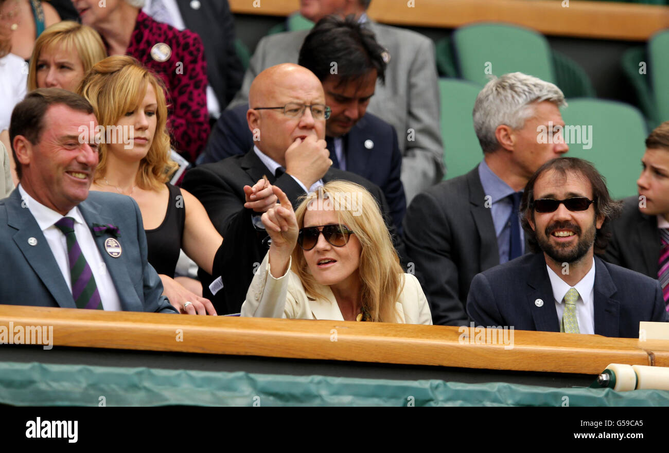 Author J.K Rowling (centre) with Wimbledon chairman Philip Brook (left) and husband Neil Murray (right) in the royal box. Stock Photo