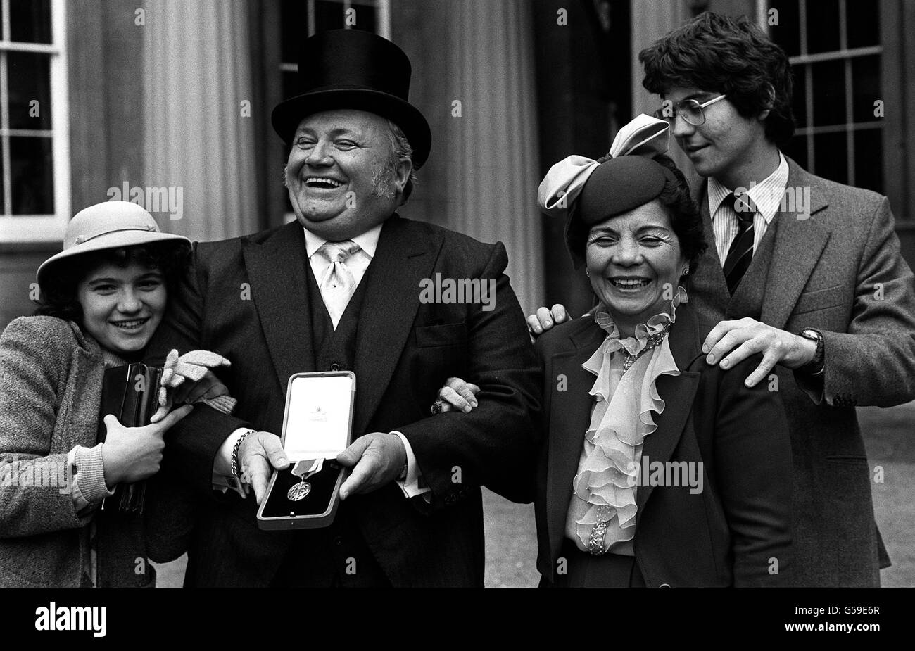 PA PHOTO 10/11/1981: SIR HARRY SECOMBE AFTER HIS INVESTITURE BY THE QUEEN AT BUCKINGHAM PALACE. WITH HIM (LEFT TO RIGHT) ARE 14 YEAR OLD DAUGHTER KATY, HIS WIFE MYRA AND THEIR 19 YEAR OLD SON DAVID. * 11/4/2001: Comedy legend Sir Harry died Wednesday April 11, 2001, his daughter Jenny Secombe has said. Stock Photo
