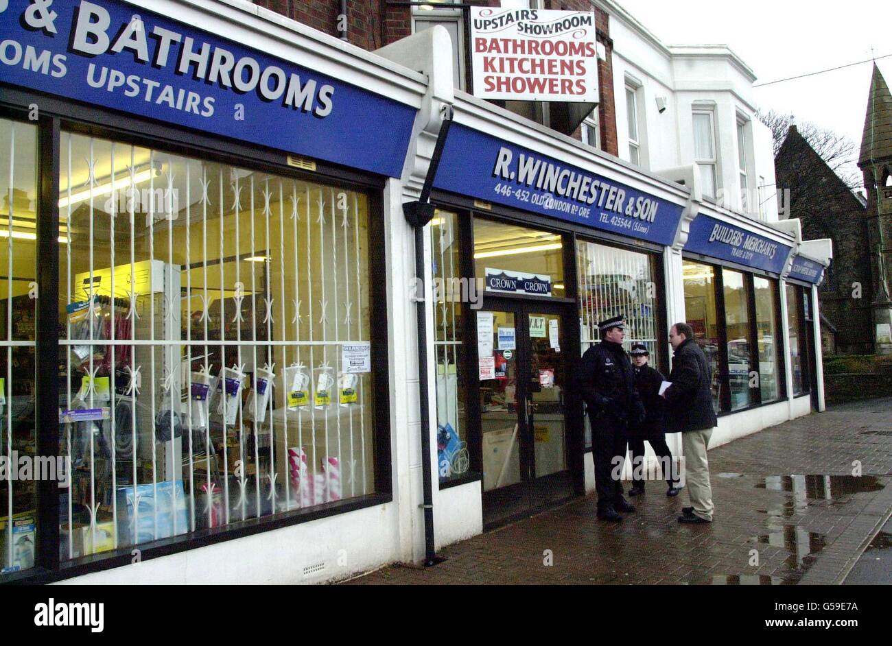 Police officers outside Builders Merchants in Old London Road in Ore, Hastings, East Sussex, close to where detectives from the Metropolitan Police, investigating the Brink's-Mat bullion robbery, are searching an area in connection with an on-going investigation. * The robbery of gold bullion and jewels worth 26 million from the Brink's-Mat vaults at London's Heathrow Airport at 6.30am on November 26, 1983, was Britain's biggest. Stock Photo