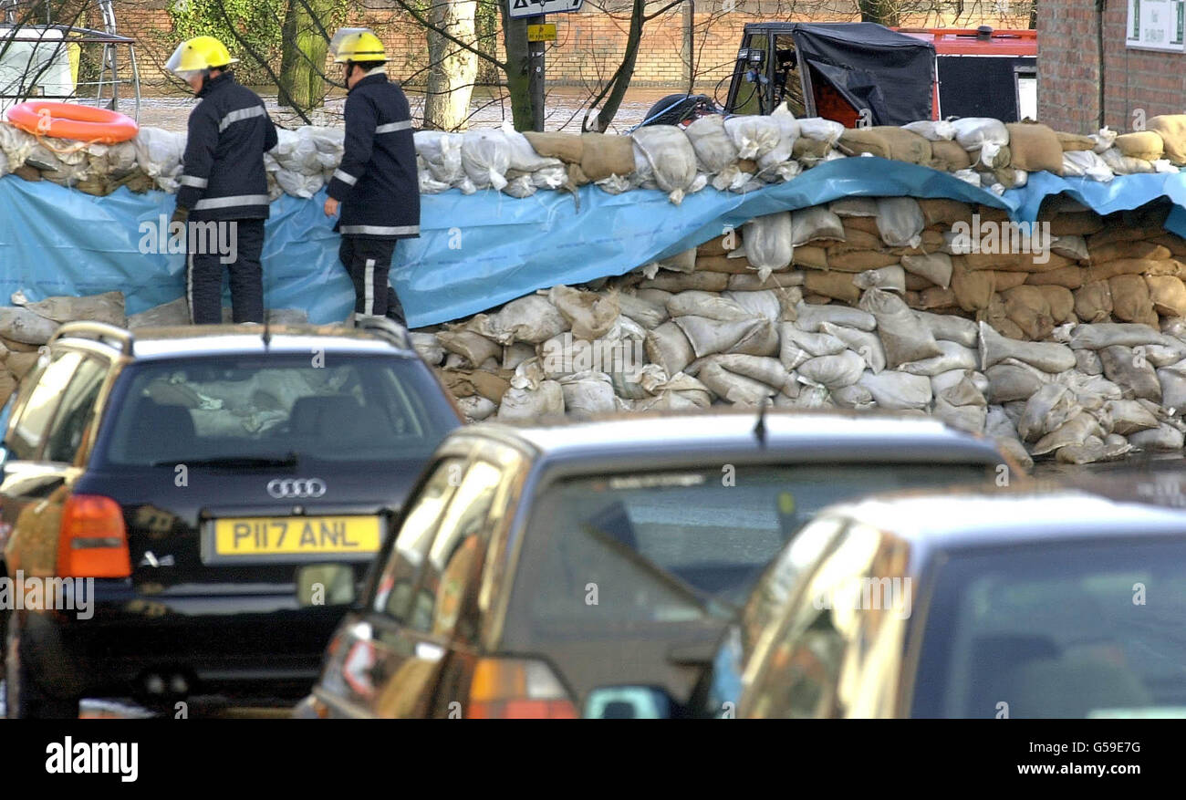 Checks are made of the rising floodwater of the River Ouse in York. A sandbag wall has been erected to try and prevent a repeat of the devastation from last Novembers flood in the Clementhorpe area of the City. Stock Photo
