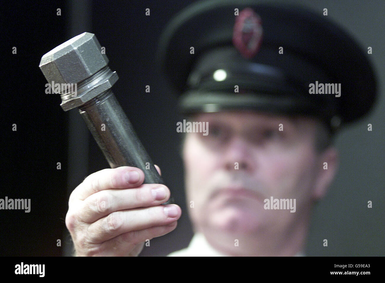 An RUC officer holds one of the explosive devices known as 'pipe bombs' used in recent attacks in the province, this home made Pipe Bomb is one of many designs used by Loyalists, since the beginning of the year their has been 44 pipe bomb attacks across the province. Stock Photo