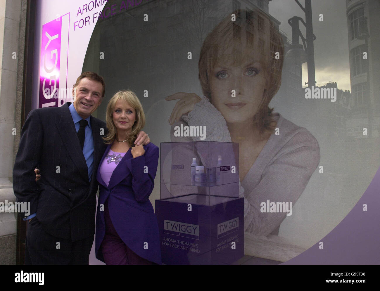 Sixties model Twiggy outside Selfridges department store with her husband, actor Leigh Lawson, in London, where her new skin care range (in display case, on right) is on sale. Stock Photo