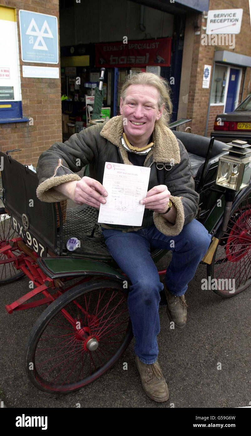 Rob Holdridge with the MOT certificate awarded to Birmingham Discovery Centre's Benz Dog Cart, a 101 yr old, three and a half horsepower open two seater. The car with a top speed of 14 mph took its test a a garage in Birmingham. Stock Photo