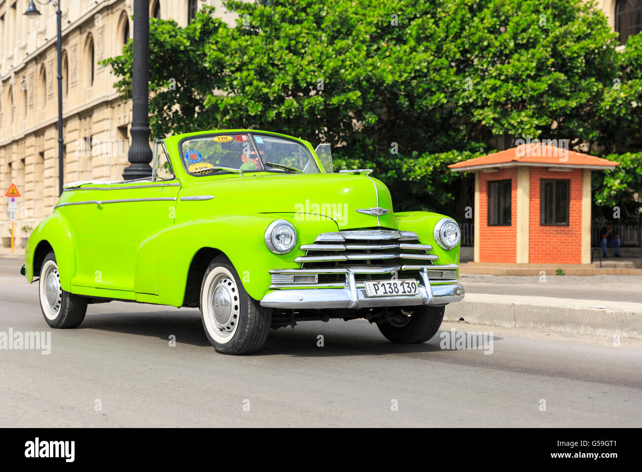 1940s lime green American Chevrolet Fleetmaster convertible classic car taxi driving in Havana, Cuba Stock Photo