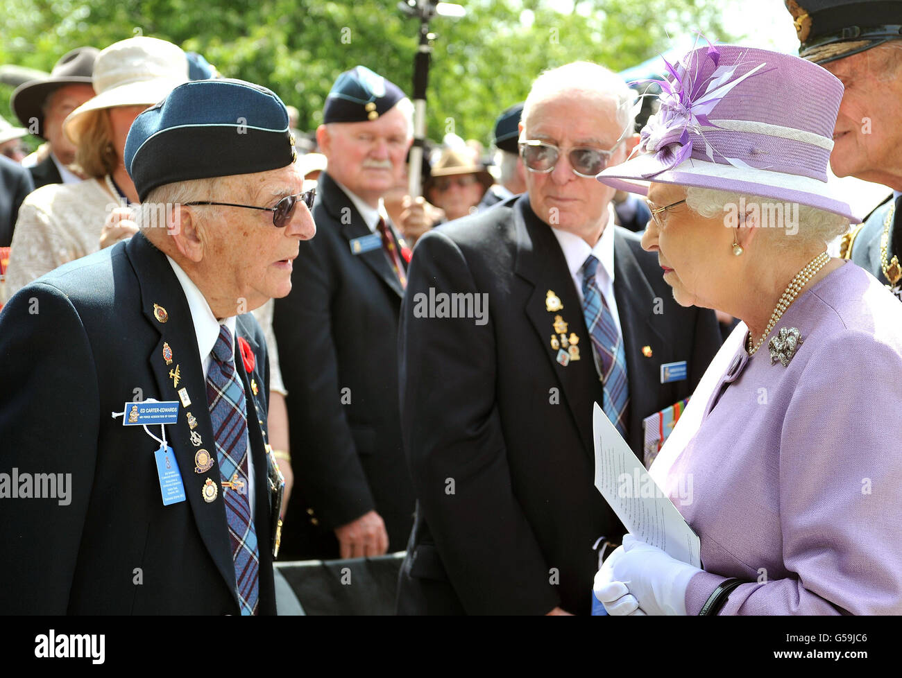 Queen Elizabeth II talks to Ed Carter-Edwards a former member of Bomber Command from Canada, after unveiling the Bomber Command Memorial in Green Park, London. Stock Photo