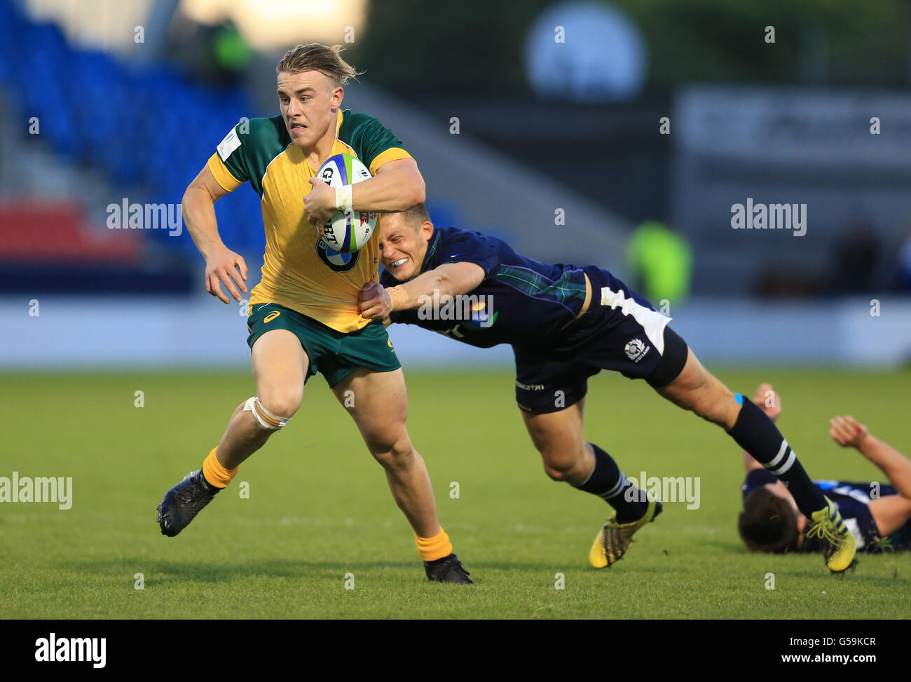 Australia's Jordan Jackson-Hope (left) evades the tackle of Scotland's Tom  Galbraith to score his sides final try of the game during the Under 20's  Rugby Union World Cup, 5th Place Semi Final
