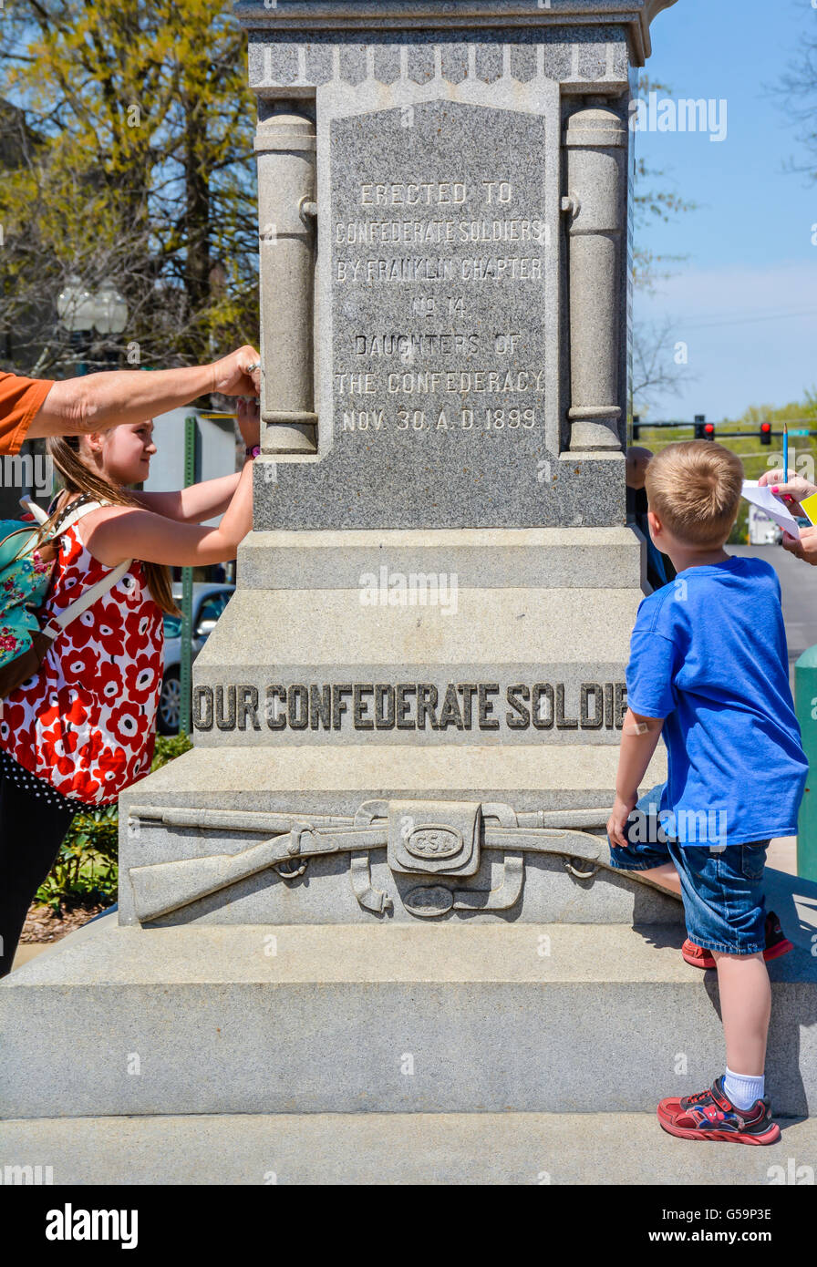 Kids explore A monument with Confederate solider atop, erected by the Daughters of the Confederacy in 1899 historic Franklin, TN Stock Photo