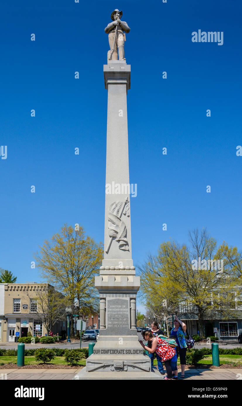 A tall granite & marble monument with a Confederate solider statute atop stands in the town square of historic Franklin, TN Stock Photo